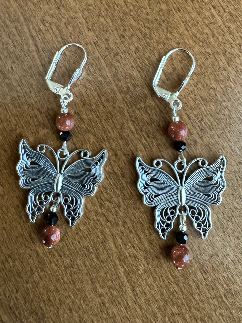 Filagree Butterfly Dangles with Goldstone Beads & Faceted Black Crystals